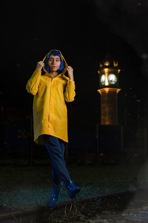 Woman in Yellow Shirt with Hood at Night