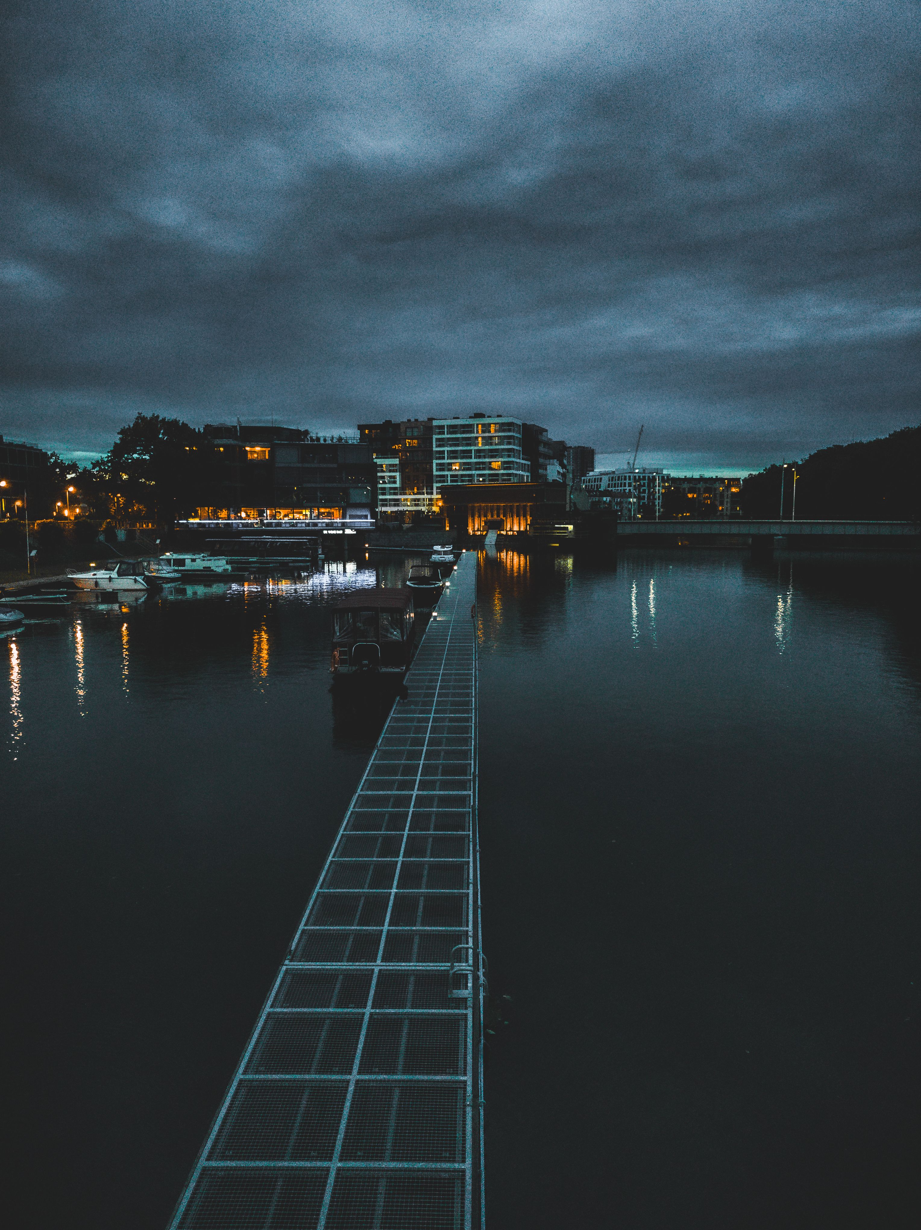 Boardwalk on Lake in Town under Clouds · Free Stock Photo