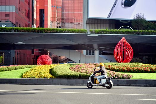 Explore a vibrant city scene in Shanghai featuring modern art and a scooter ride.