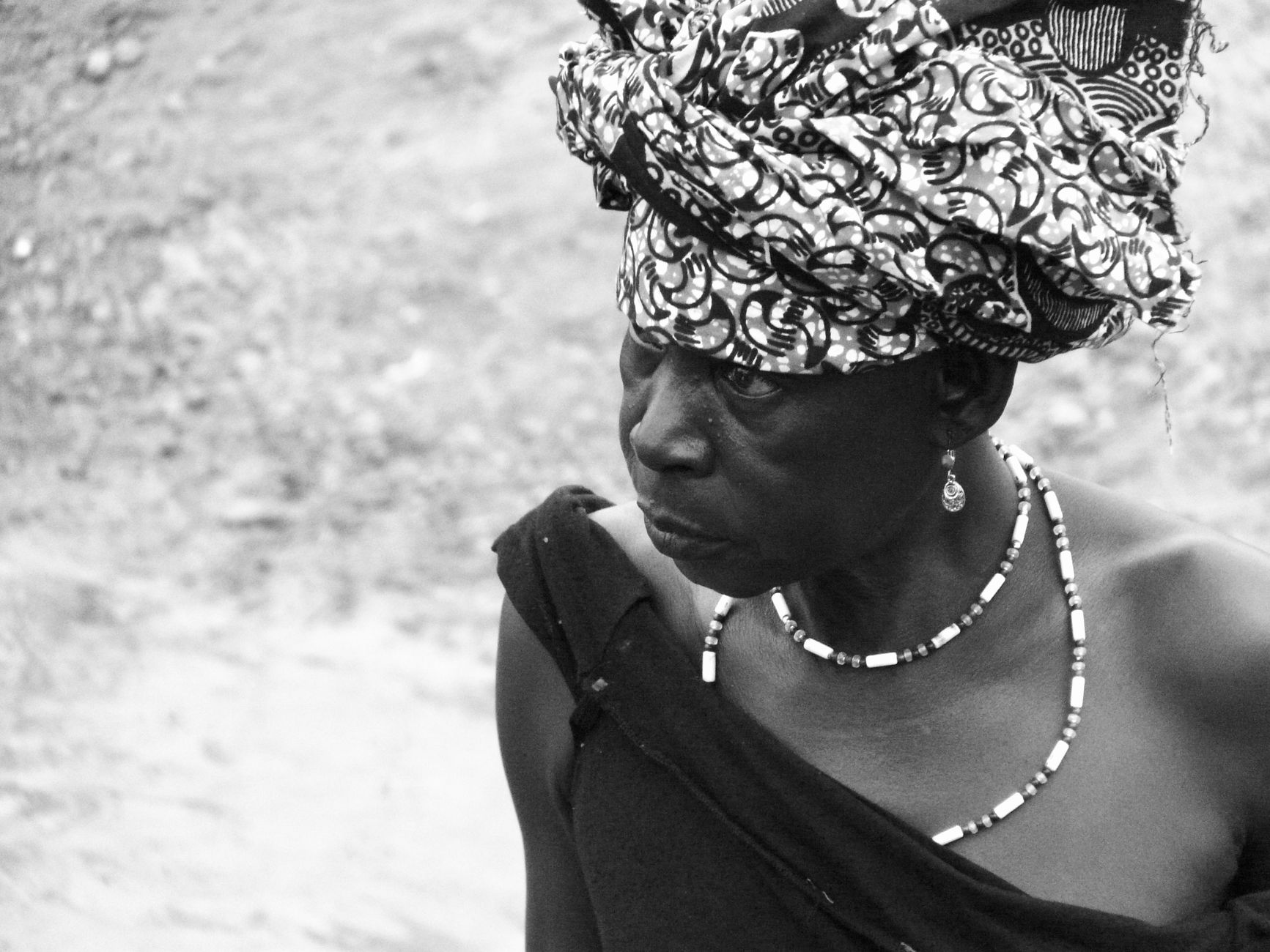 Black and white portrait of a woman in traditional attire from Burkina Faso.