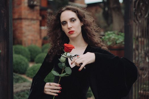 Portrait of Woman Cutting Red Rose with Garden Sears