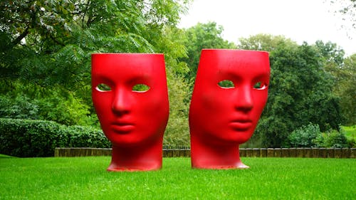 Free Red Human Face Monument on Green Grass Field Stock Photo