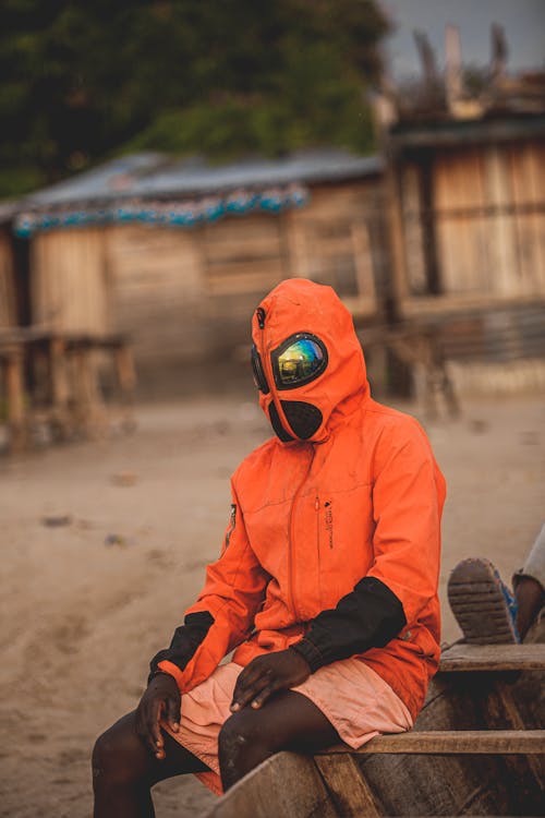 Man Sitting in Goggles and Jacket with Hood