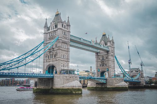 Free Scenic view of Tower Bridge in London on an overcast day, capturing urban architecture. Stock Photo