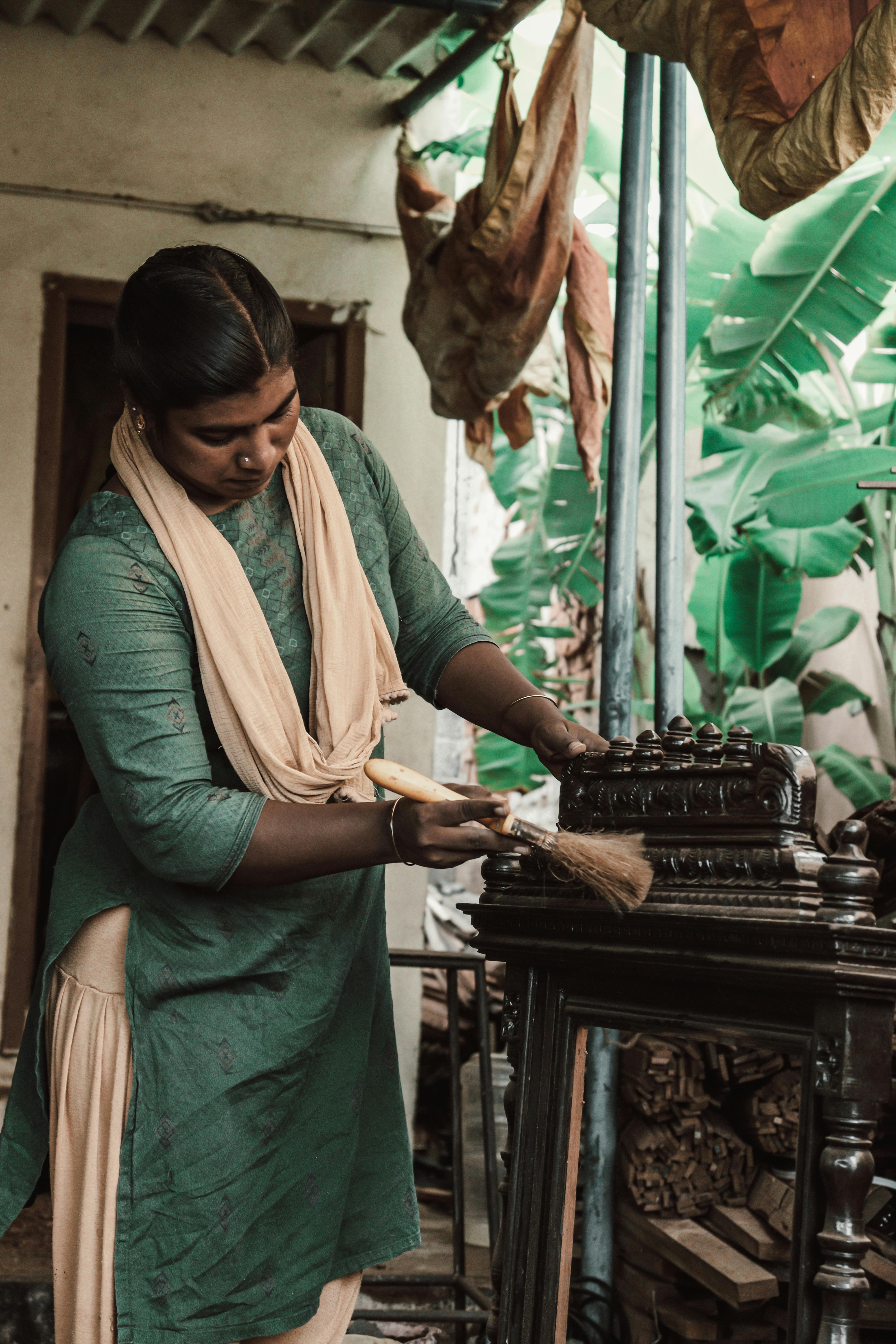 Woman Wearing a Green Sari Dusting Antique Furniture · Free Stock Photo