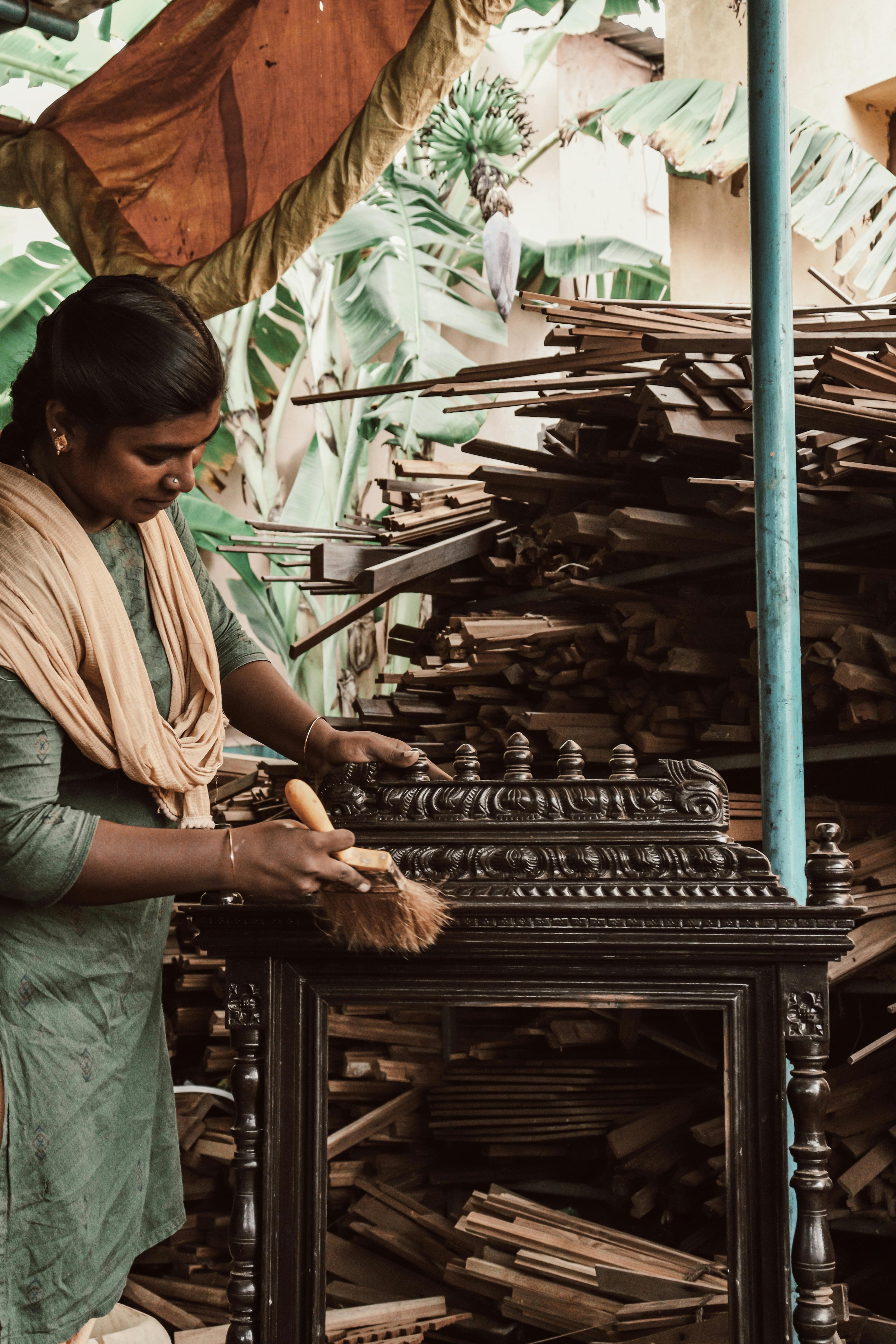 Woman Wearing a Green Sari Dusting Antique Furniture · Free Stock Photo