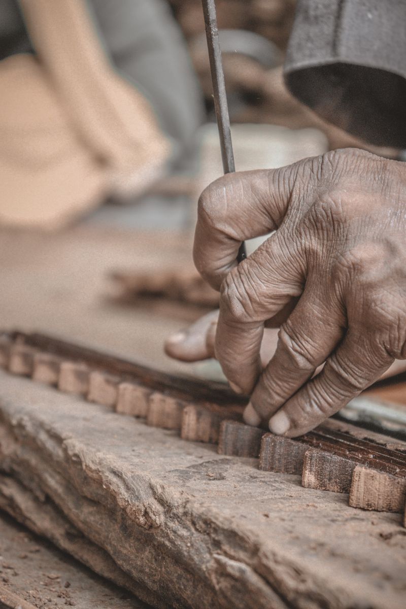 An experienced maker's hands working at a bench