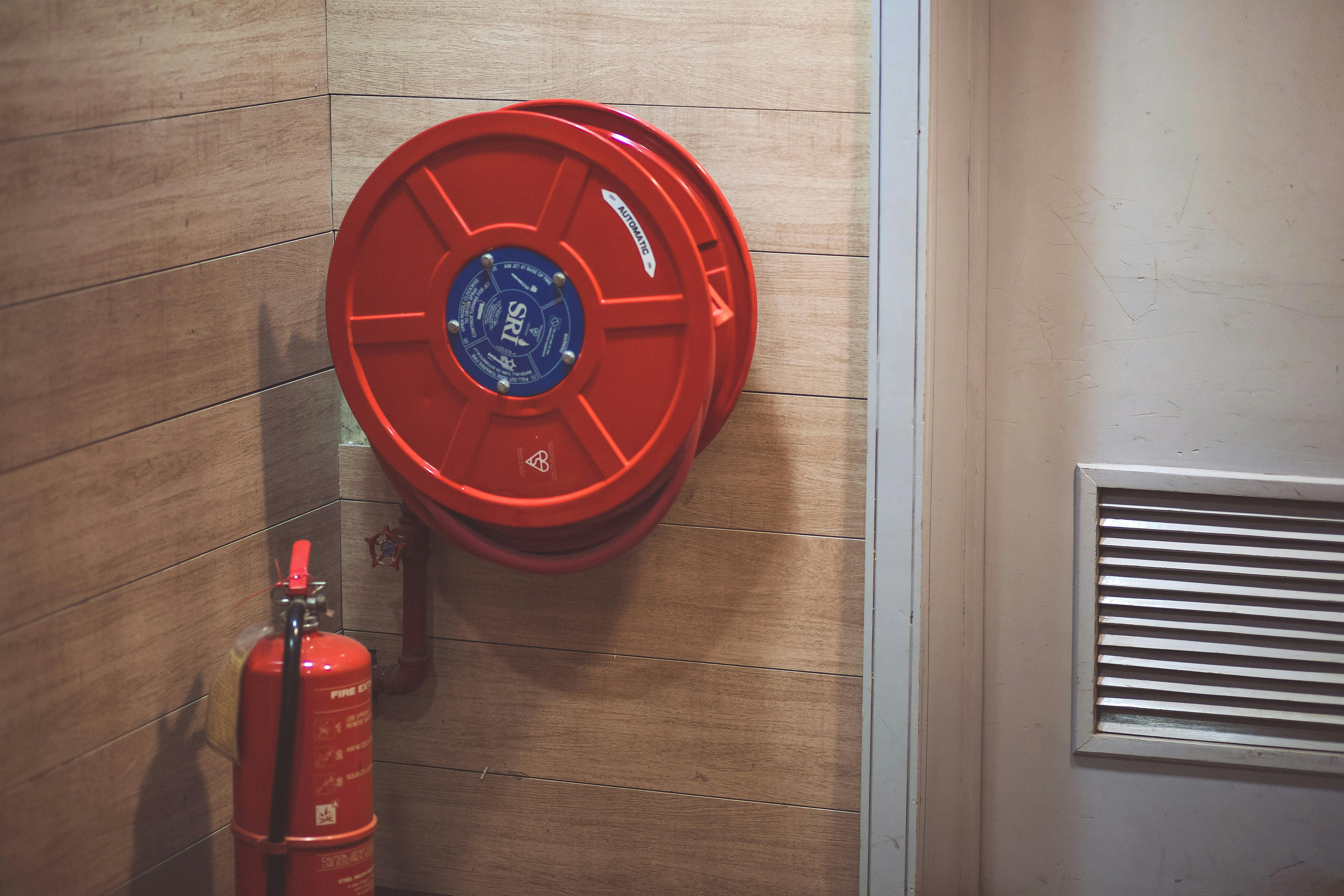Red Fire Extinguisher Beside Hose Reel Inside The Room Free