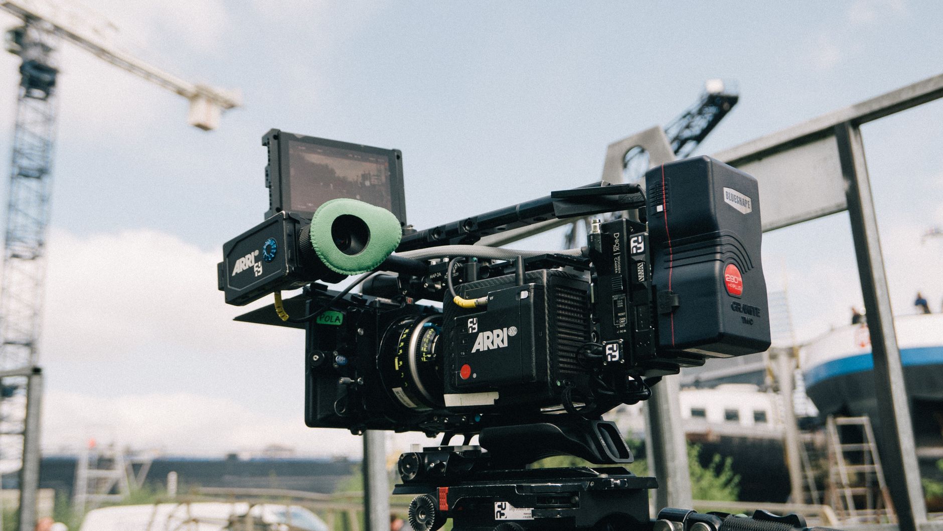 Professional film camera setup outdoors capturing a scene with blurred background.