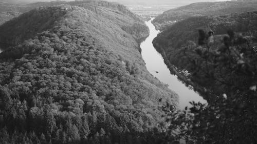 Black and White Aerial Shot of Hills and a River 