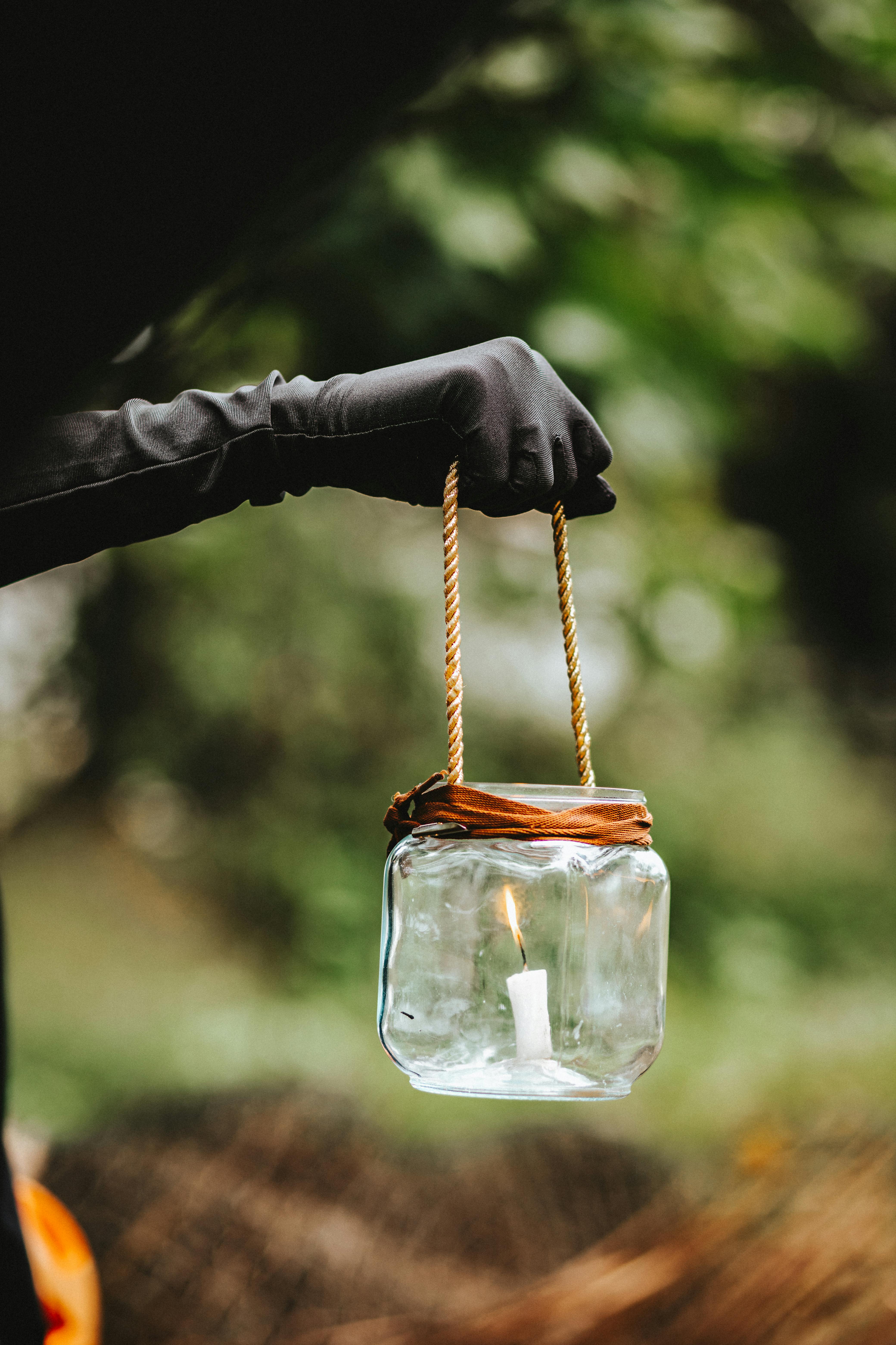 hand in leather glove holding lantern