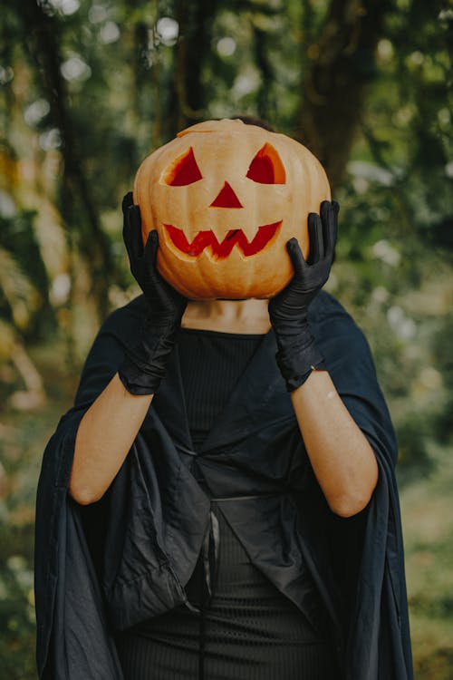 Woman Holding Carved Pumpkin