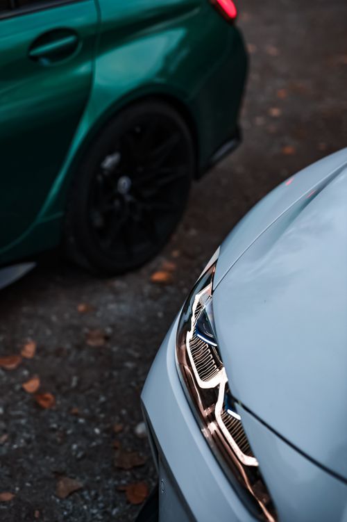 Free Close-up view of luxury car grilles in an outdoor autumn setting, focusing on design and sophistication. Stock Photo