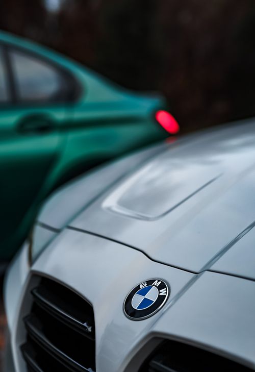 Free BMW car hood and logo in focus, emphasizing modern design in an outdoor setting. Stock Photo