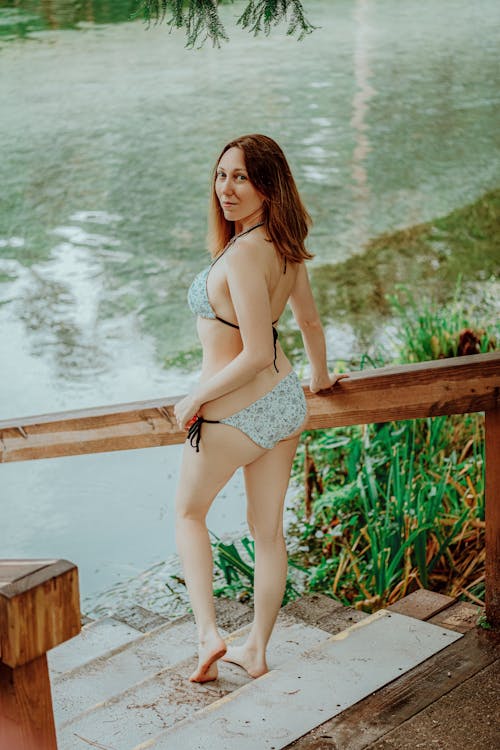 Woman in Bikini on Steps by Lake