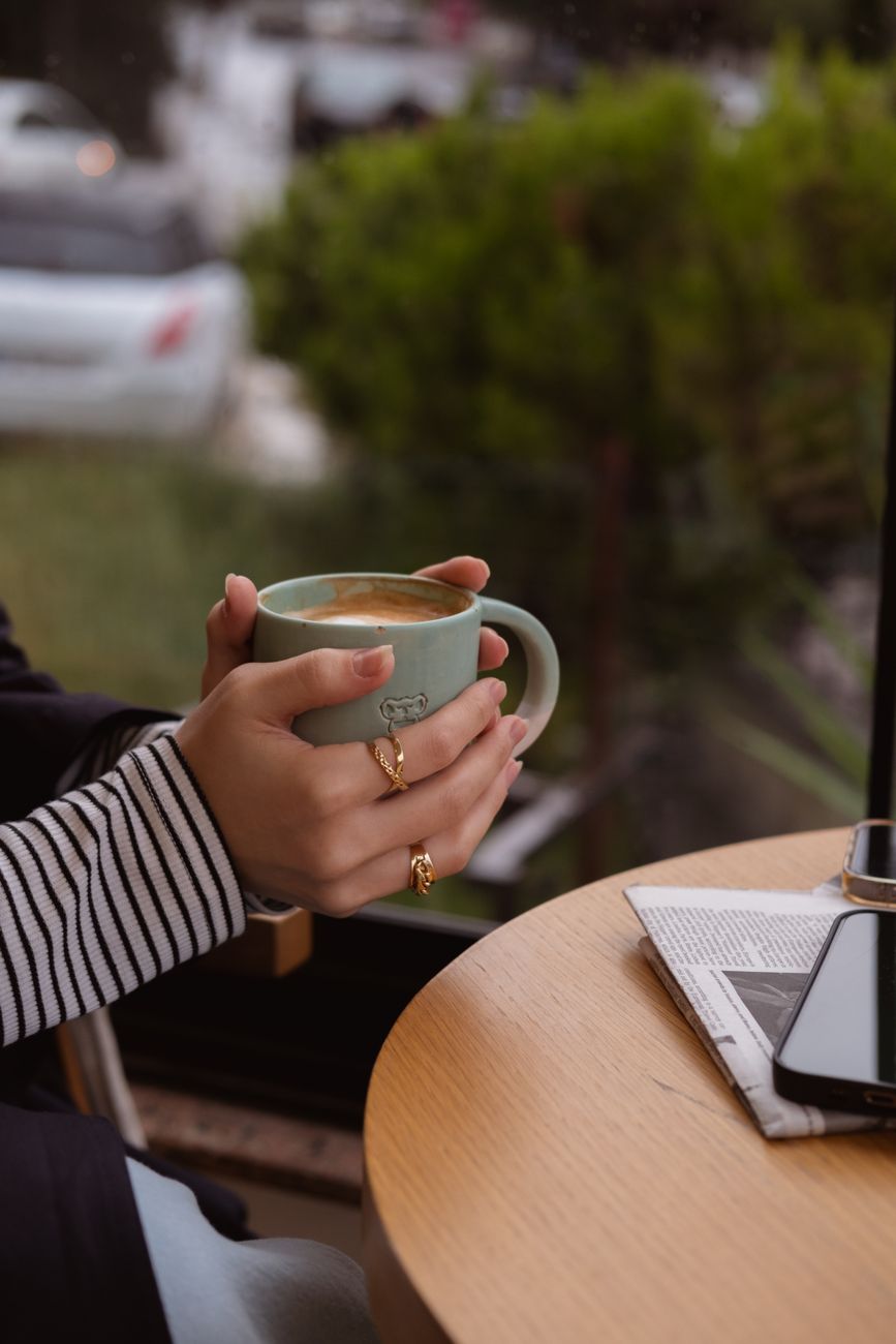 Woman enjoying a coffee break at a cafe, holding a mug. Perfect for lifestyle and relaxation themes.. pexels, woman, enjoying