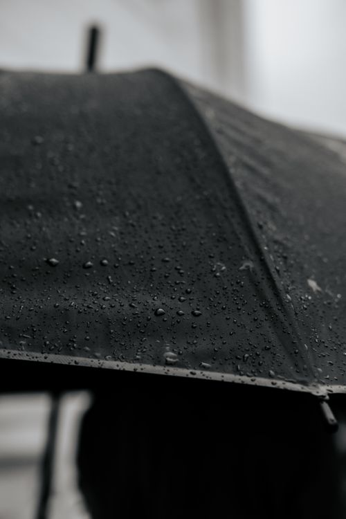 Free A detailed close-up of a black umbrella covered with raindrops on a rainy day in Istanbul. Stock Photo