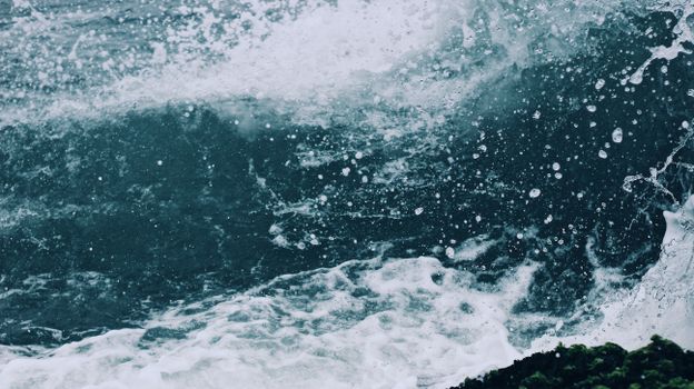 Energetic ocean waves creating dramatic splashes and foam, showcasing nature's power.