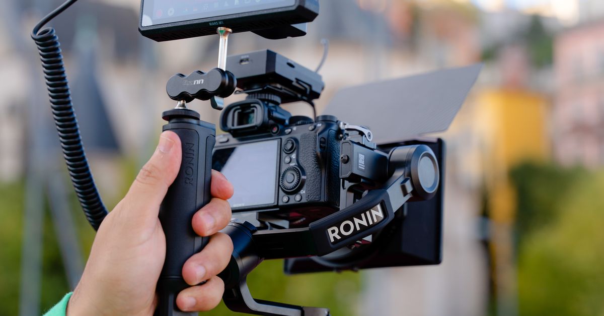 Camera Operators Outside Close-up of a Man Operating a Camera Outside in City · Free Stock Photo