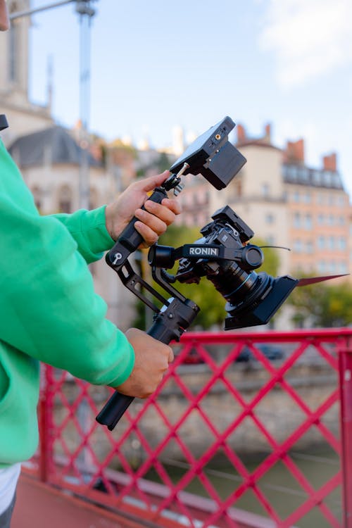 Close-up of a Man Operating a Camera Outside in City