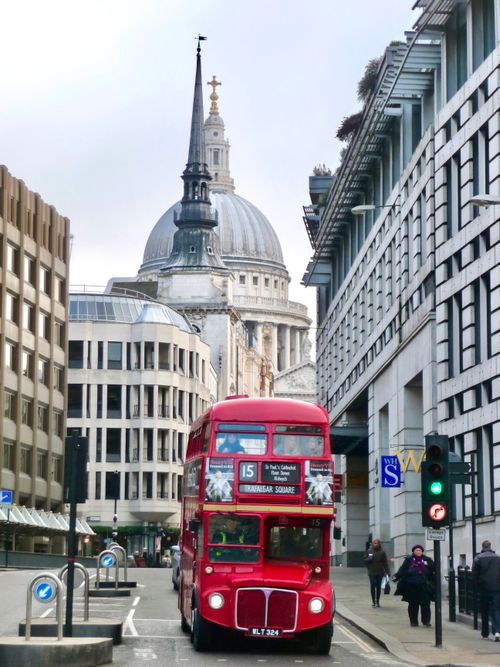 Free A classic red double-decker bus in front of St Paul's Cathedral, capturing London's charm. Stock Photo