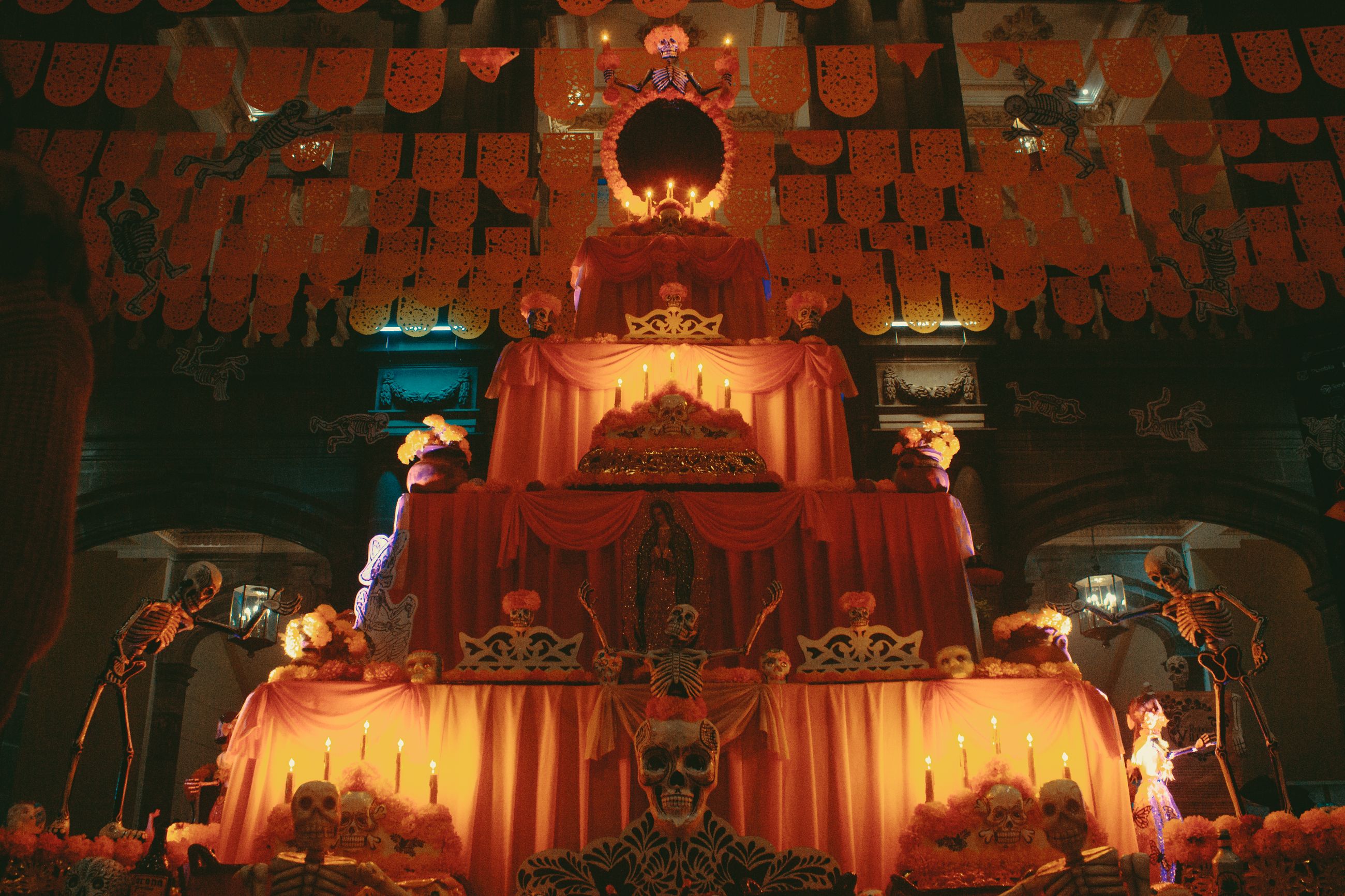 Day of the Dead altar in Mexico with candles, cempasuchil marigolds and papel picado