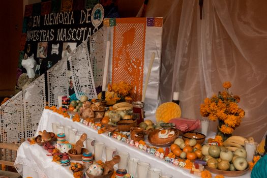 Colourful Dia de Muertos altar showcasing Mexican traditions in Puebla, Mexico with marigolds and candles.