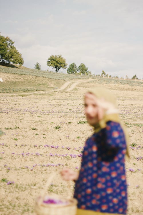 Person with a Basket Standing in a Field