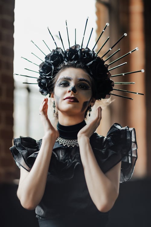 Woman Wearing a Black Dress and Makeup for Halloween 