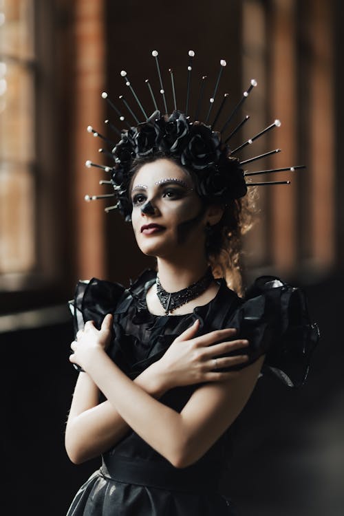 Woman Wearing a Black Dress and Makeup for Halloween 