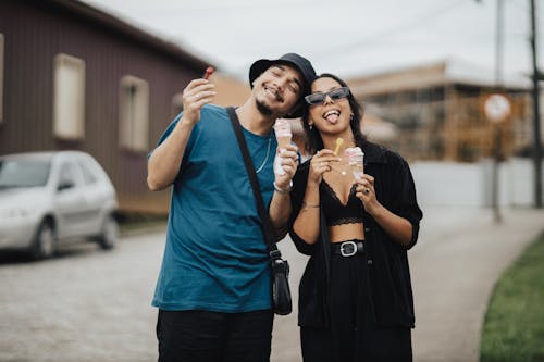 Young Man and Woman Eating Ice Cream and Smiling 