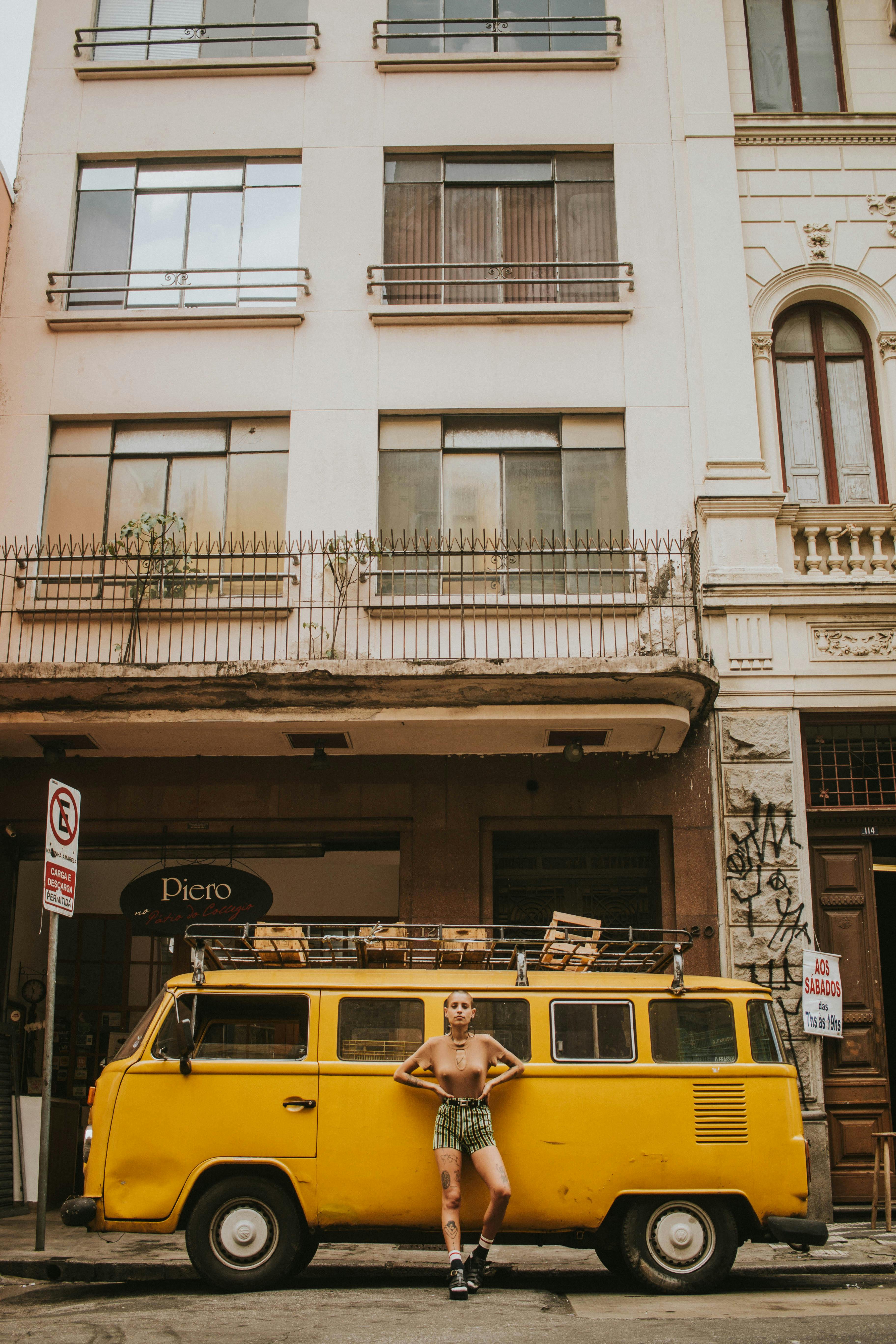 Woman Leaning on Yellow Bus