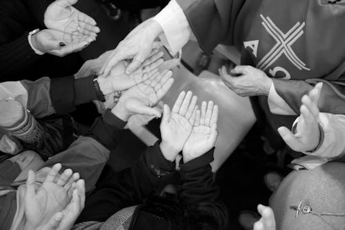 Priest and Worshippers Hands in Black and White