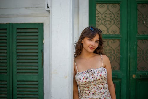 Portrait of Woman in Sundress Standing by Wall