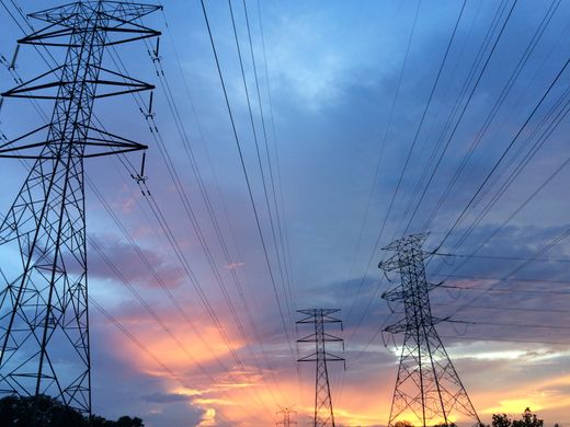 High-voltage power lines at sunset — photo by Pok Rie on Pexels