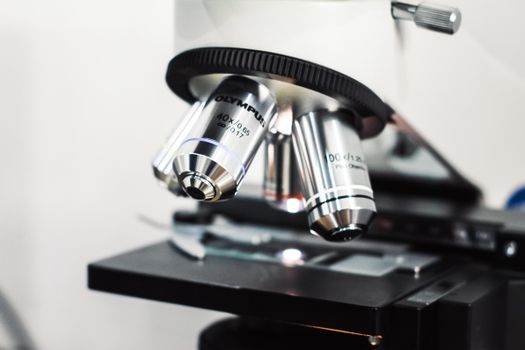 Detailed view of an Olympus microscope used for scientific research in a laboratory setting.