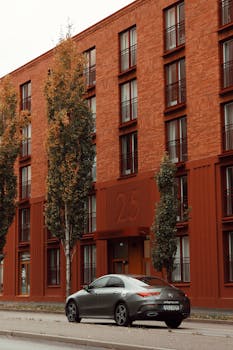 Contemporary building facade in Jönköping, Sweden with a grey car parked in the foreground.