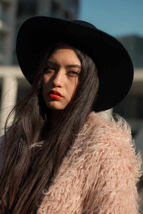 Brunette Woman in Black Hat and Pink Faux Fur Coat Free Stock Photo