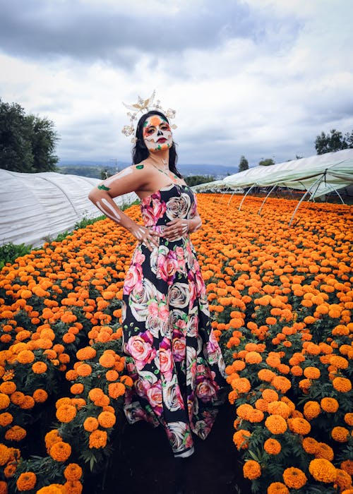 Woman in Floral Pattern Maxi Dress and Headdress Posing at a Marigold Plantation