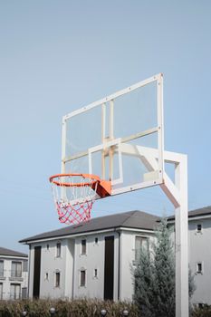 Basketball hoop in a residential area, perfect for urban sports themes.