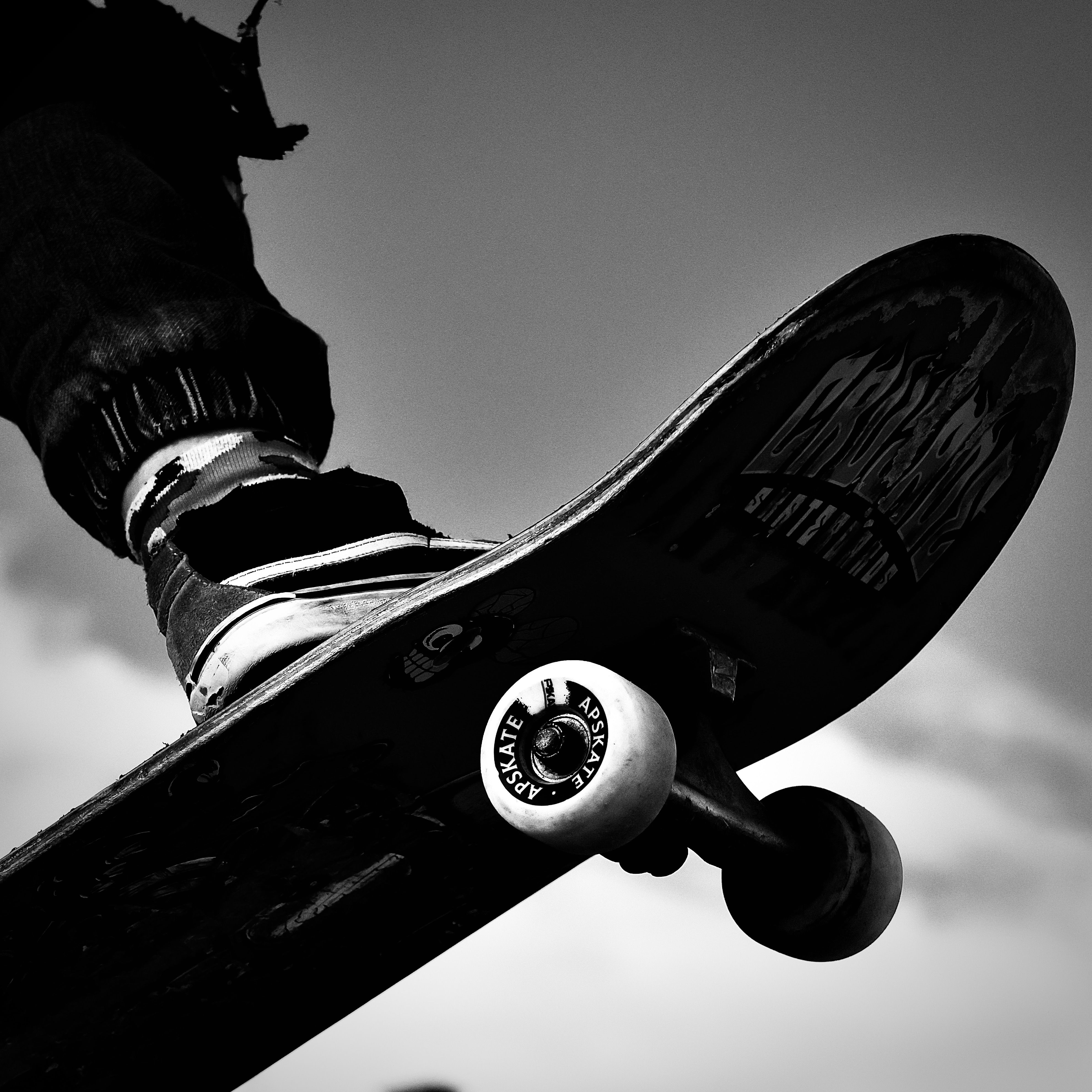 Man Riding on Skateboard in Black and White