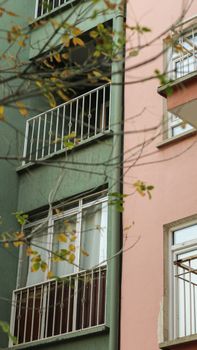 Close-up view of apartment buildings with balconies and colorful facades.