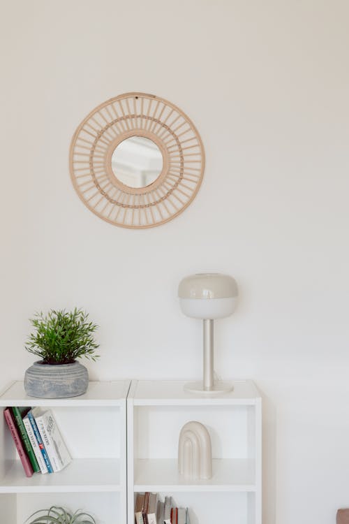 White Furniture and a Round Mirror in a Room 
