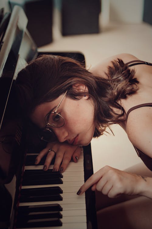 Woman Leaning on Piano Keys