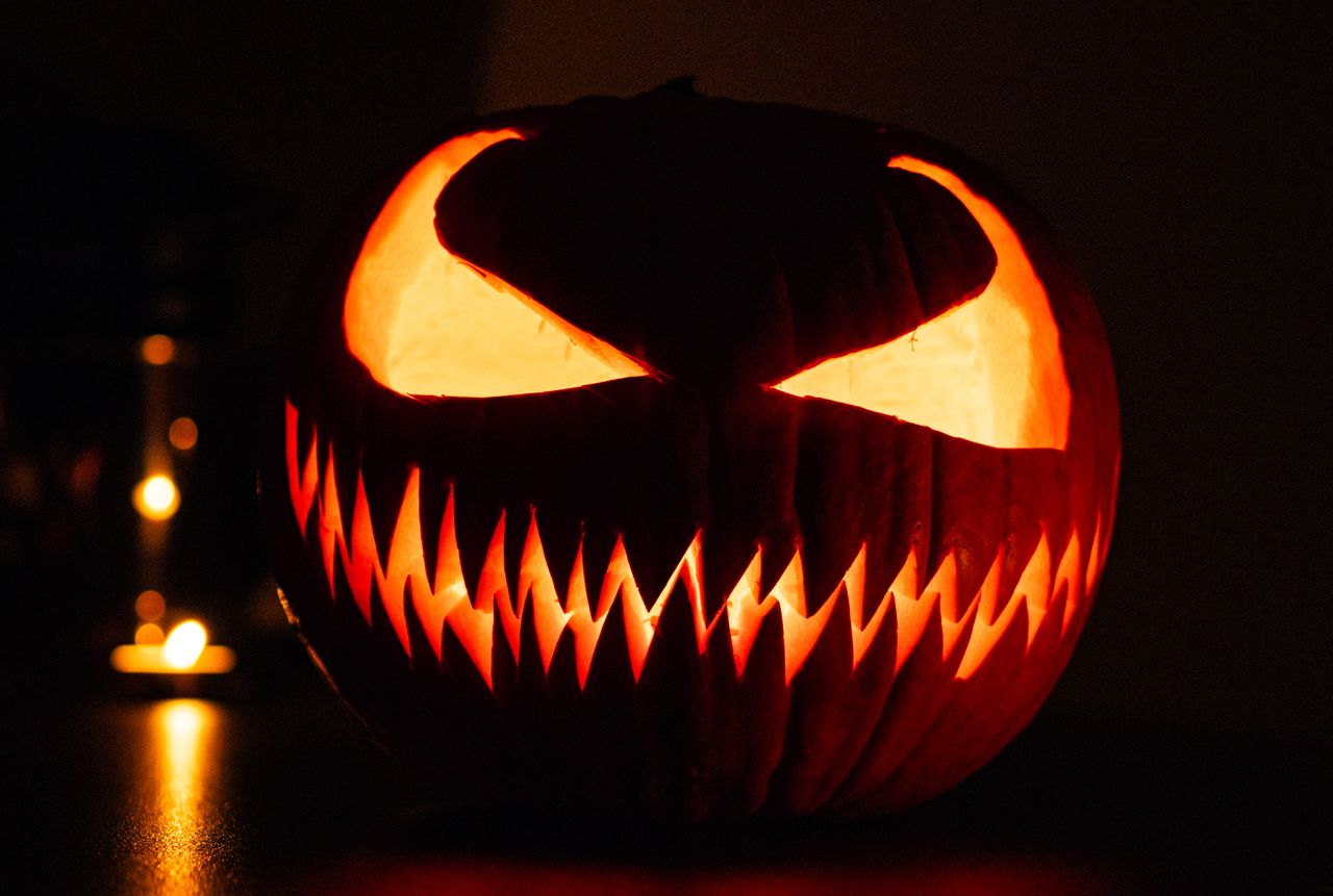 eerie carved halloween pumpkin glowing in the dark perfect for festive
