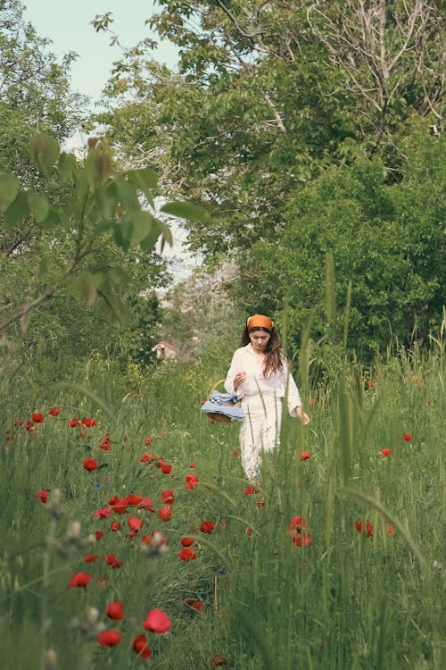 Woman Walking on a Meadow with Poppies 