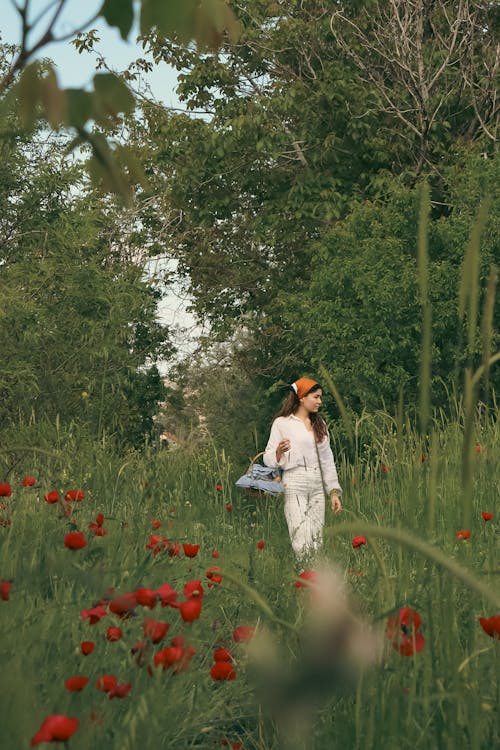 Woman Walking on a Meadow with Poppies 