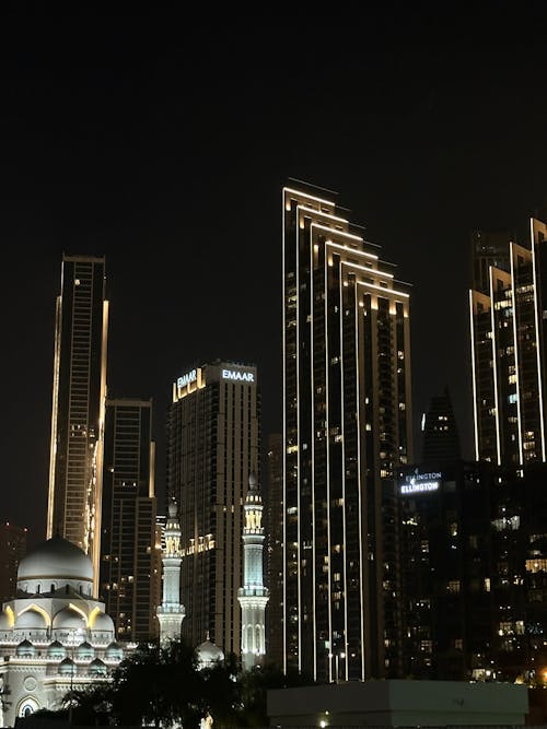 Illuminated Mosque and Skyscrapers in Downtown Dubai, UAE
