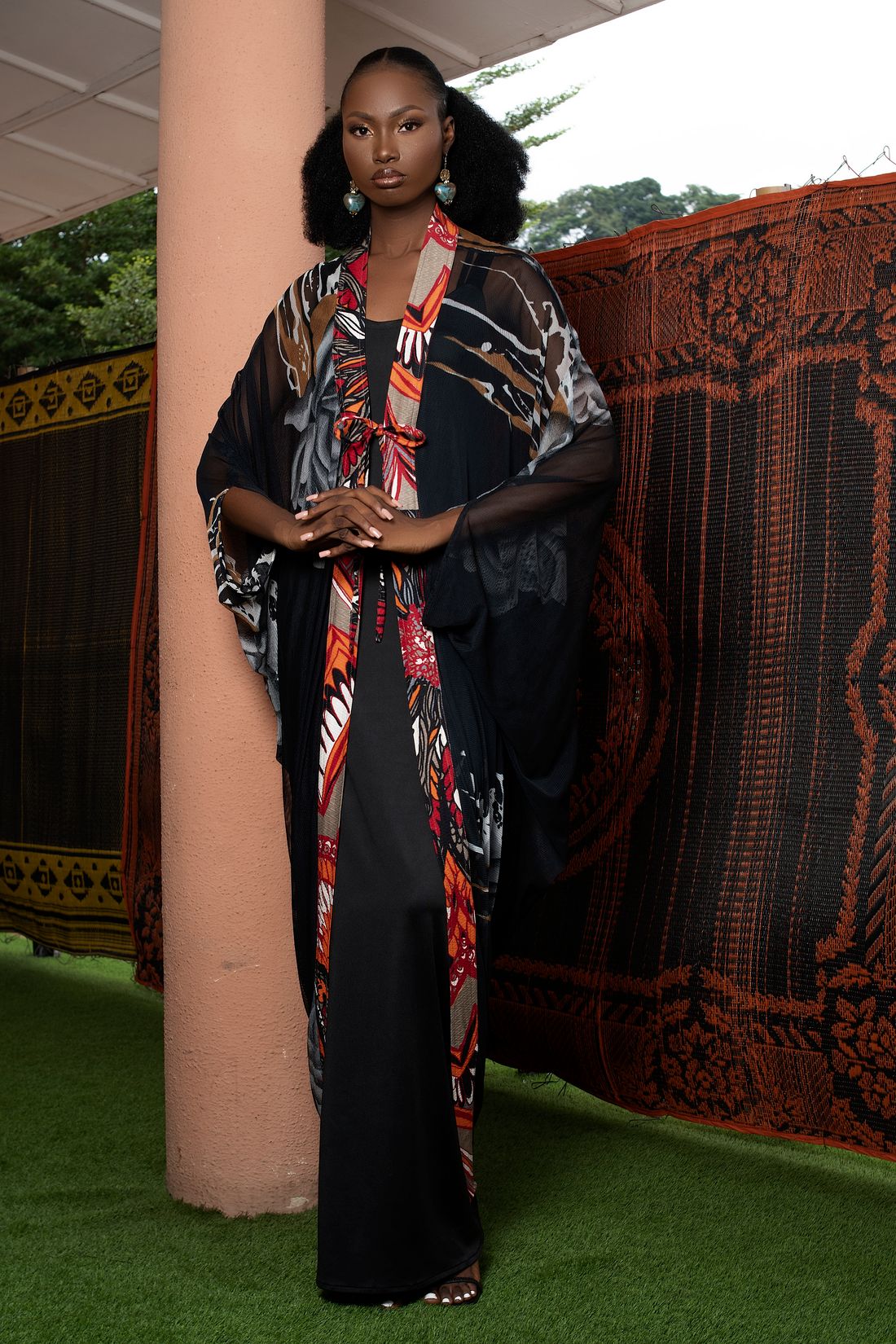 Black fashion model wearing a patterned statement outfit