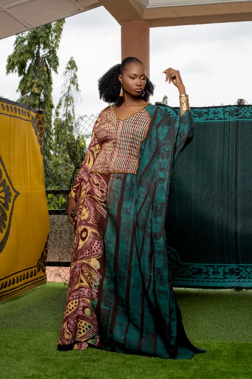 Free A stylish woman in African traditional fashion poses confidently outdoors. Stock Photo
